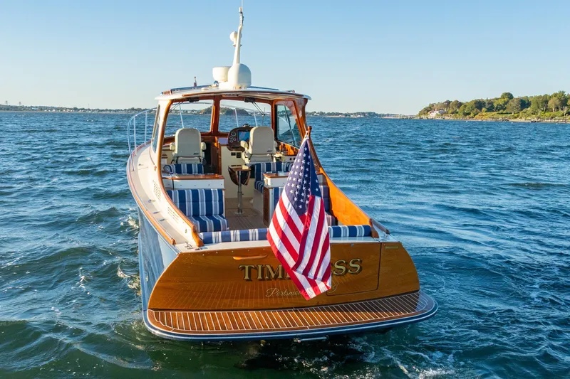 Slide: The Image of 2015 Hinckley Picnic Boat MK III cruising on open water, American flag displayed. - 6