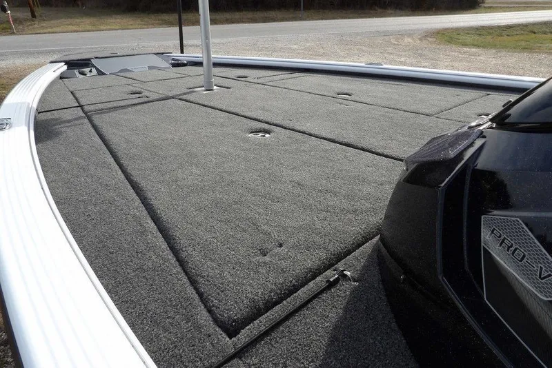 Slide: The Image of 2026 Lund 2075 Pro-V Bass XS boat deck with gray carpeted surface. - 10