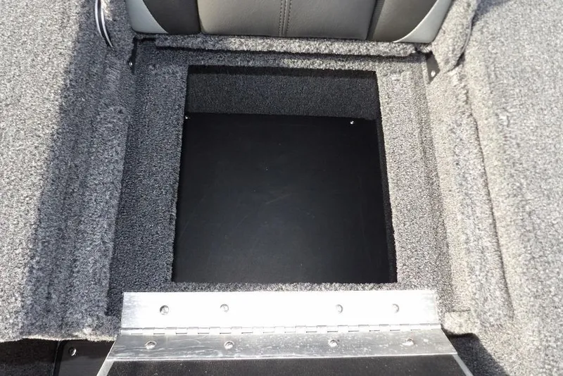 Slide: The Image of 2026 Lund 2075 Pro-V Bass XS storage compartment with carpeted interior. - 22