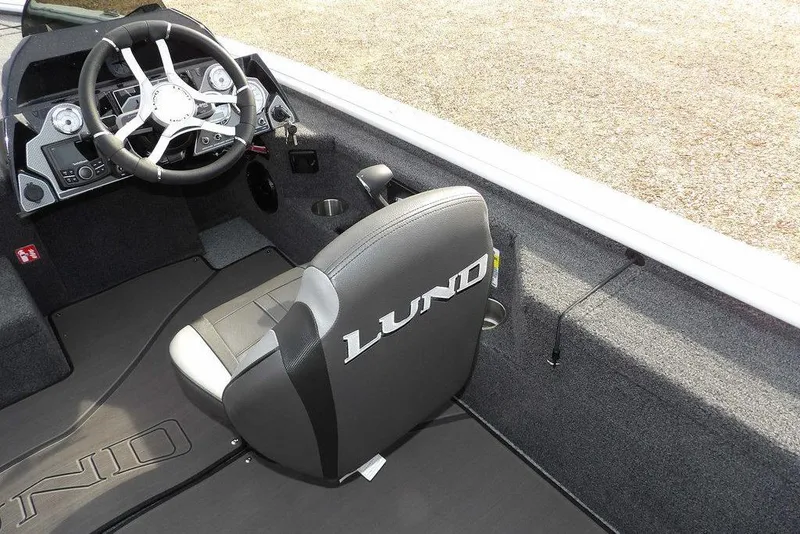 Slide: The Image of 2026 Lund 2075 Pro-V Bass XS boat interior with steering wheel and branded seat. - 28