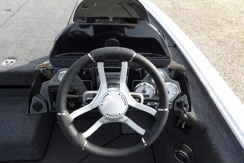Slide: The Image of Steering console of 2026 Lund 2075 Pro-V Bass XS boat with gauges and controls. - 29