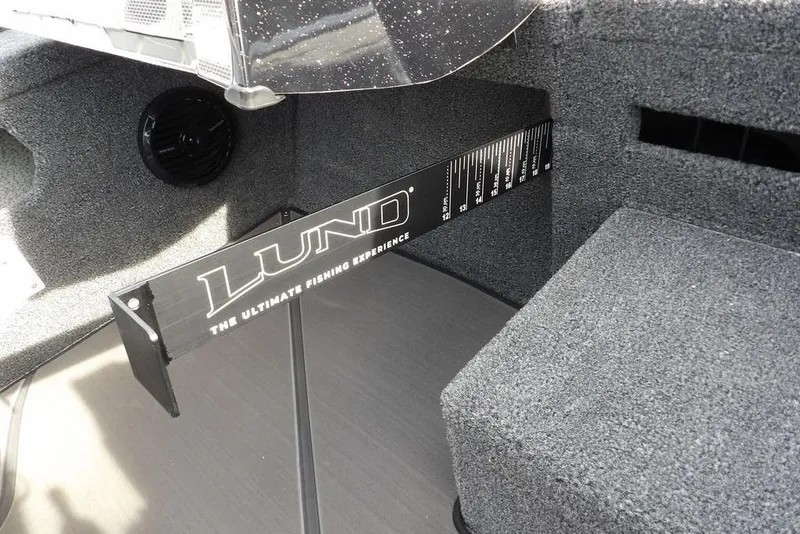 Slide: The Image of 2026 Lund 2075 Pro-V Bass XS interior with measurement tool and speaker. - 34