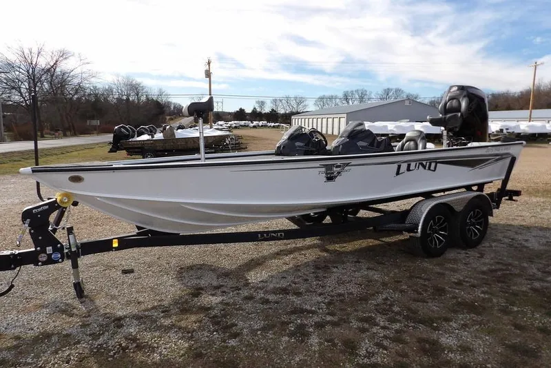 Slide: The Image of 2026 Lund 2075 Pro-V Bass XS boat on trailer, parked outdoors. - 4