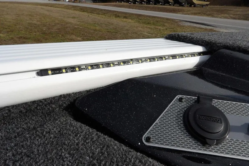 Slide: The Image of 2026 Lund 2075 Pro-V Bass XS boat interior with LED strip lighting and textured surfaces. - 44