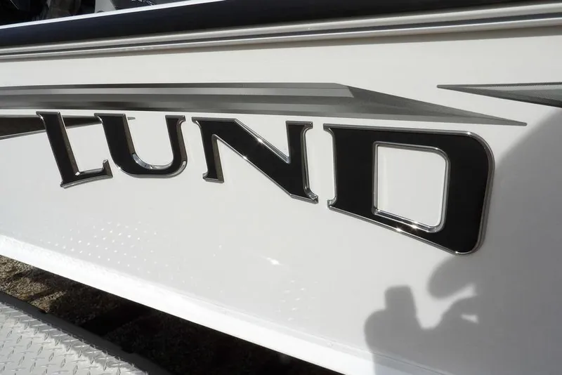 Slide: The Image of 2026 Lund 2075 Pro-V Bass XS boat logo on white exterior. - 49