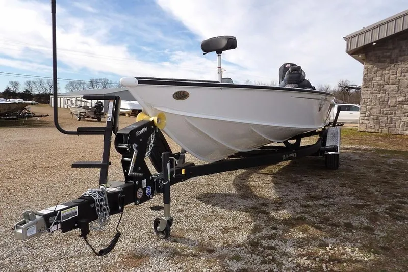 Slide: The Image of 2026 Lund 2075 Pro-V Bass XS boat on trailer, parked outdoors. - 50