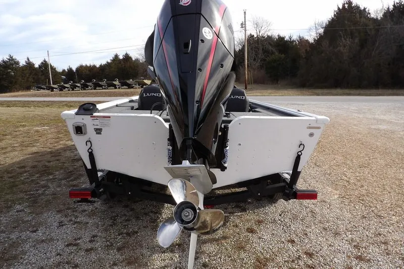 Slide: The Image of 2026 Lund 2075 Pro-V Bass XS boat rear view with outboard motor and propeller. - 6