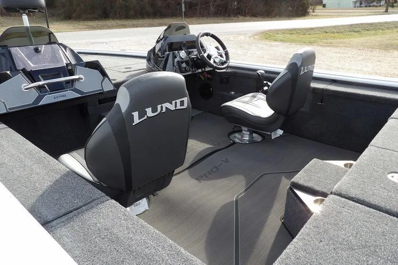 Slide: The Image of 2026 Lund 2075 Pro-V Bass XS boat interior with steering console and seating. - 7