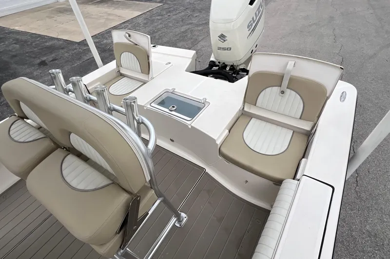 Slide: The Image of 2019 Sea Born FX24 Bay boat interior with Suzuki 250 engine, featuring beige and white seating. - 10