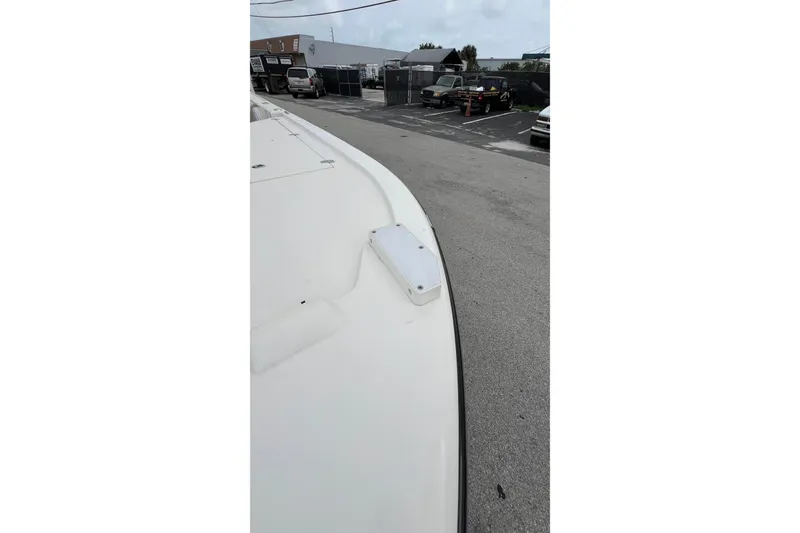 Slide: The Image of 2019 Sea Born FX24 Bay boat in a parking lot, showcasing its sleek design. - 13