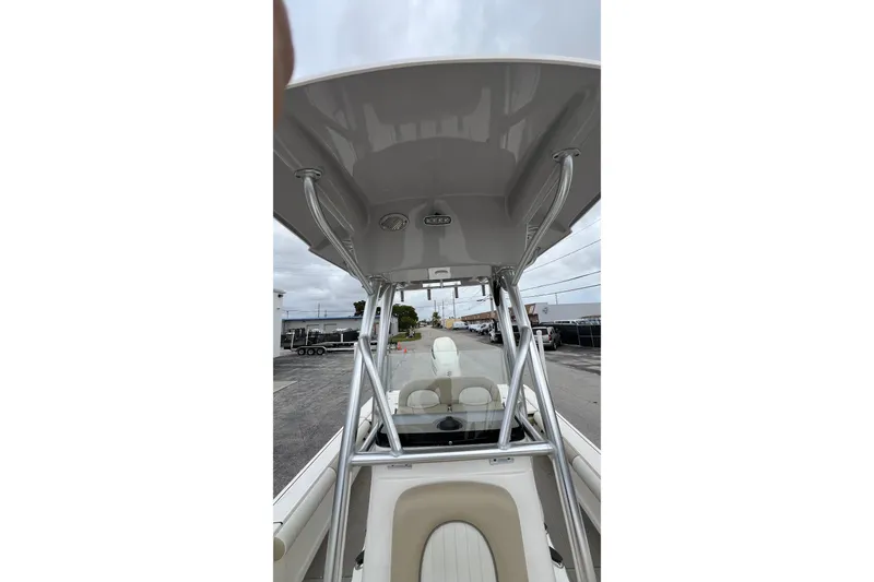 Slide: The Image of 2019 Sea Born FX24 Bay boat with T-top and seating, docked outdoors. - 19