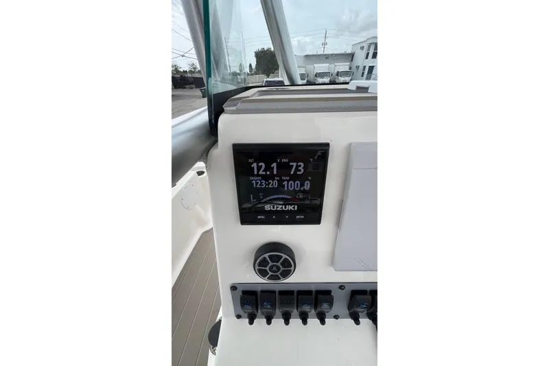 Slide: The Image of 2019 Sea Born FX24 Bay boat dashboard with Suzuki display and controls. - 23