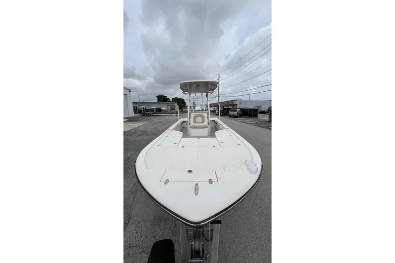 Slide: The Image of 2019 Sea Born FX24 Bay boat, white deck, parked outdoors under cloudy sky. - 3
