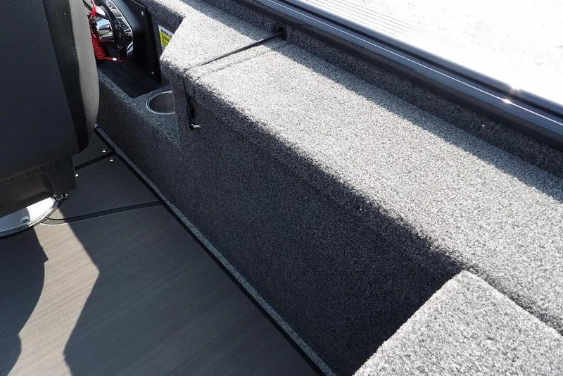 Slide: The Image of 2026 Lund 2075 Pro-V Bass XS interior with carpeted storage and seating area. - 20