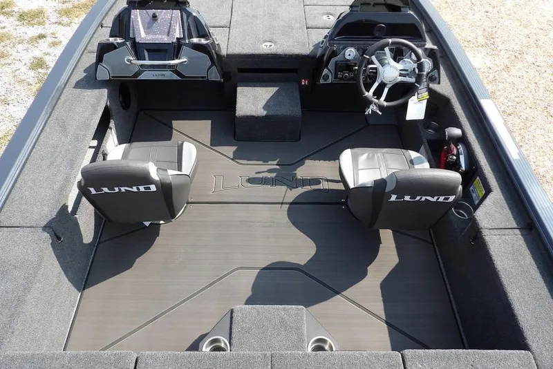 Slide: The Image of 2026 Lund 2075 Pro-V Bass XS boat interior with dual seats and steering console. - 24