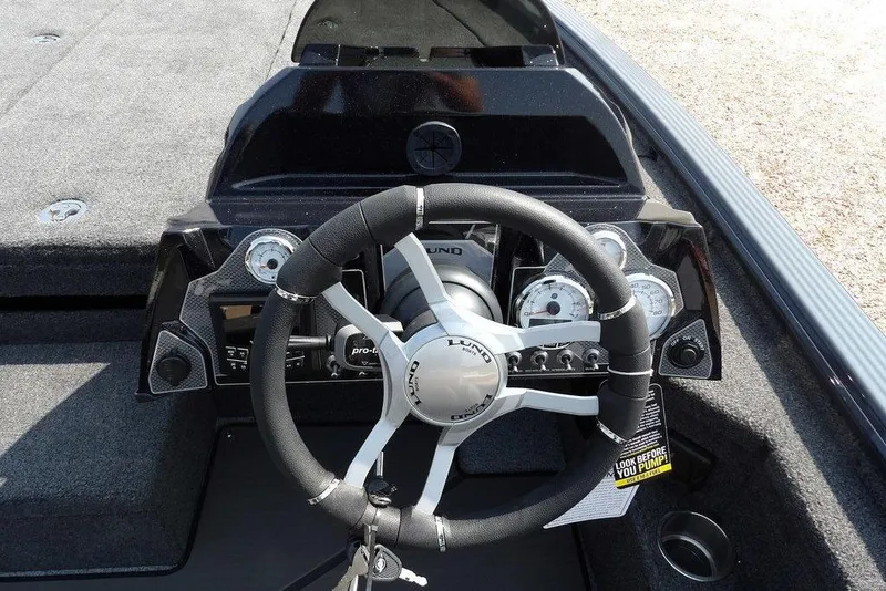 Slide: The Image of Steering console of 2026 Lund 2075 Pro-V Bass XS boat with modern gauges and controls. - 28