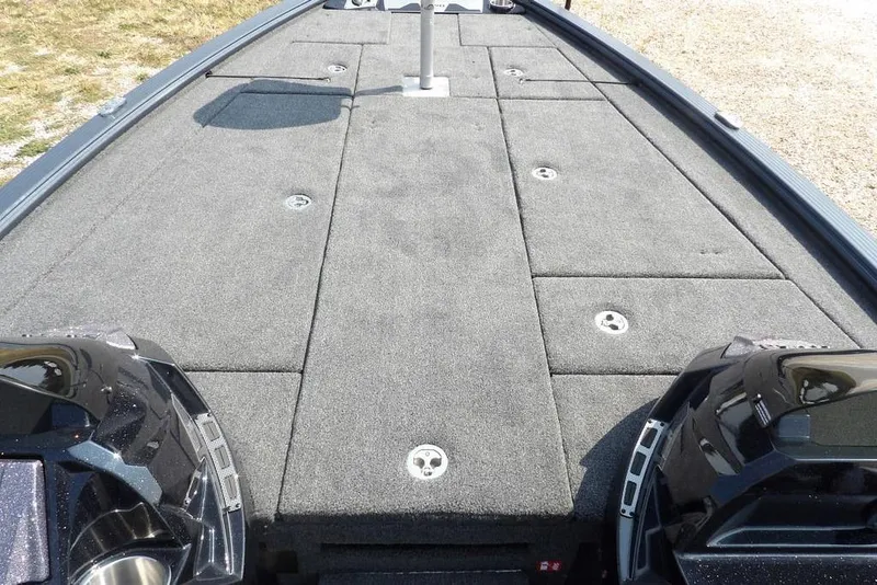 Slide: The Image of 2026 Lund 2075 Pro-V Bass XS boat deck with carpeted surface and storage compartments. - 36
