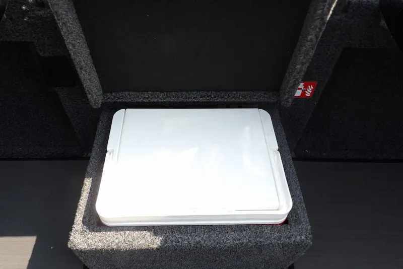 Slide: The Image of Storage compartment in 2026 Lund 2075 Pro-V Bass XS boat, featuring a white lid. - 39