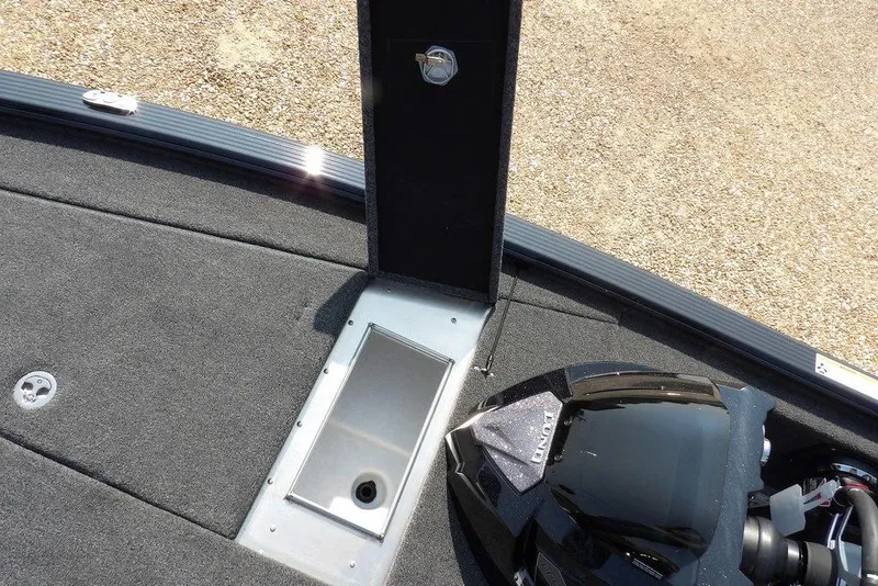 Slide: The Image of 2026 Lund 2075 Pro-V Bass XS boat interior with storage compartment and sleek design. - 41