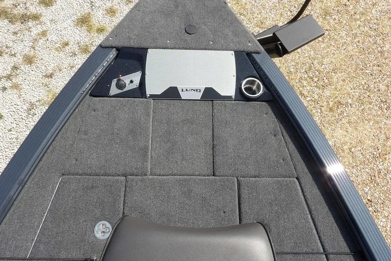 Slide: The Image of 2026 Lund 2075 Pro-V Bass XS boat deck with carpeted surface and storage compartments. - 52