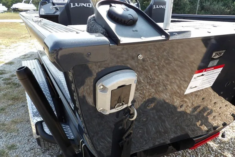 Slide: The Image of 2026 Lund 2075 Pro-V Bass XS boat rear view with motor mount and safety warning. - 62