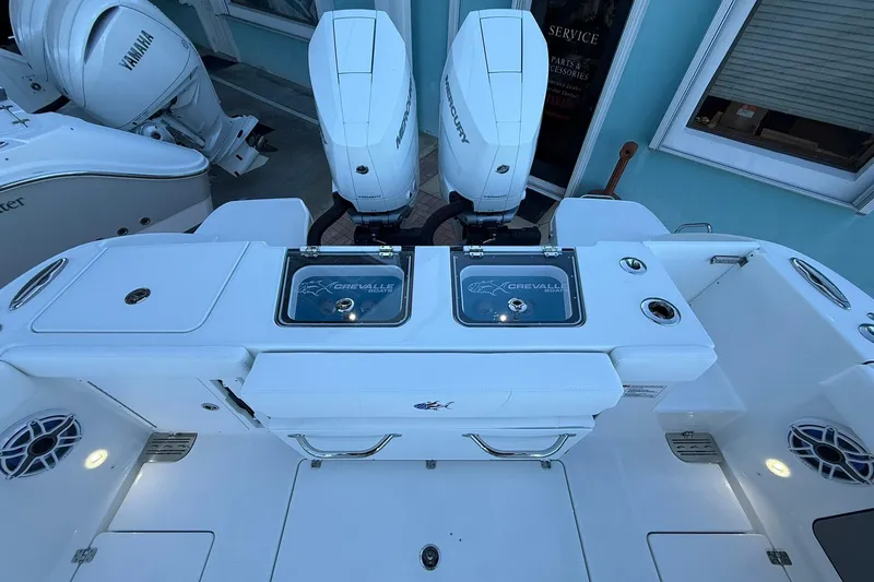 Slide: The Image of 2026 Crevalle 33 CSF boat with dual Mercury engines and Yamaha motor in a showroom. - 14