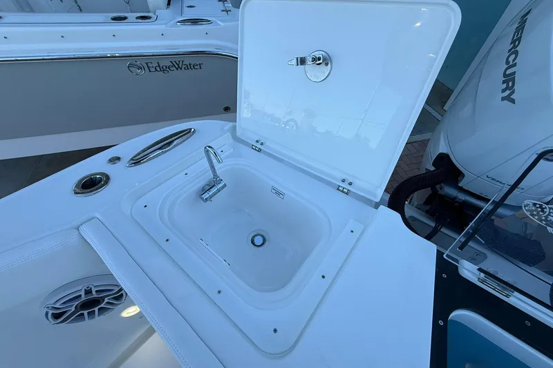 Slide: The Image of Open hatch on 2026 Crevalle 33 CSF boat, featuring a built-in sink and faucet. - 17