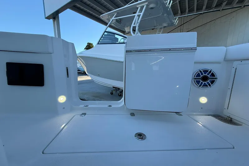 Slide: The Image of 2026 Crevalle 33 CSF boat interior with seating, speaker, and storage compartment. - 23