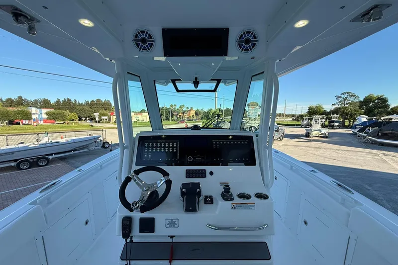 Slide: The Image of 2026 Crevalle 33 CSF boat cockpit with modern controls and steering wheel. - 25