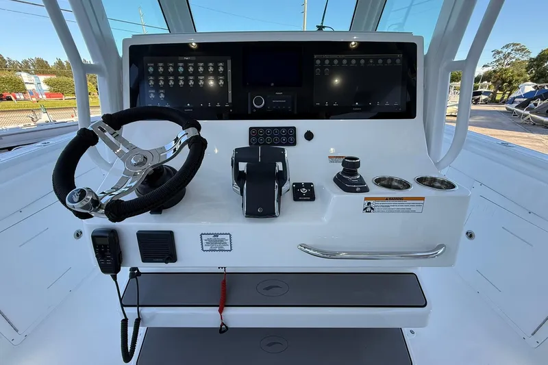 Slide: The Image of 2026 Crevalle 33 CSF boat dashboard with steering wheel and modern controls. - 26