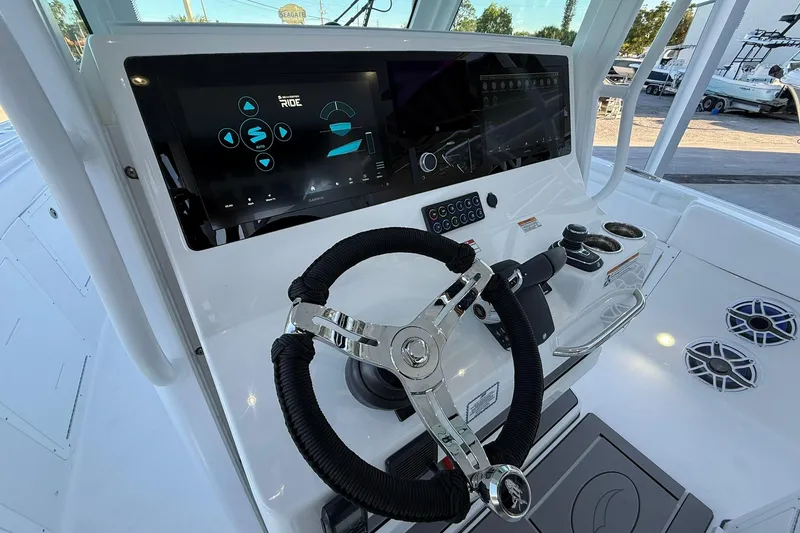 Slide: The Image of 2026 Crevalle 33 CSF boat dashboard with modern controls and steering wheel. - 27
