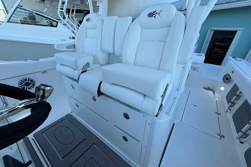 Slide: The Image of 2026 Crevalle 33 CSF boat interior with luxurious white seating and storage compartments. - 31