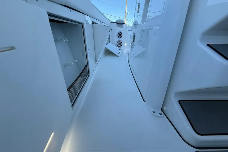 Slide: The Image of 2026 Crevalle 33 CSF boat interior with open storage compartments and speakers. - 34