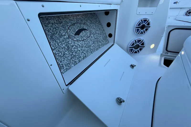 Slide: The Image of 2026 Crevalle 33 CSF boat interior with storage compartment and speakers. - 37