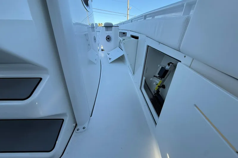 Slide: The Image of 2026 Crevalle 33 CSF boat interior with open storage compartments and sleek white design. - 40