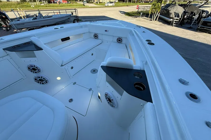 Slide: The Image of 2026 Crevalle 33 CSF boat interior with seating, cup holders, and speakers. - 46