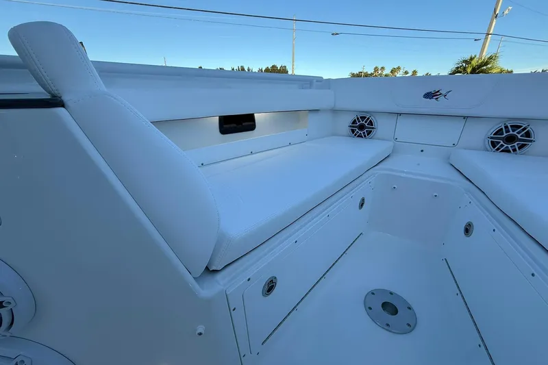 Slide: The Image of 2026 Crevalle 33 CSF boat interior with white seating and speakers. - 52