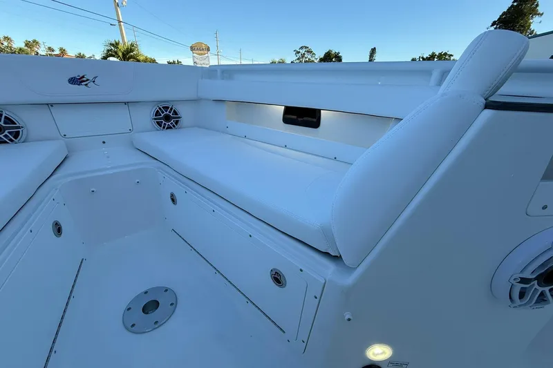 Slide: The Image of 2026 Crevalle 33 CSF boat interior with white seating and speakers. - 53