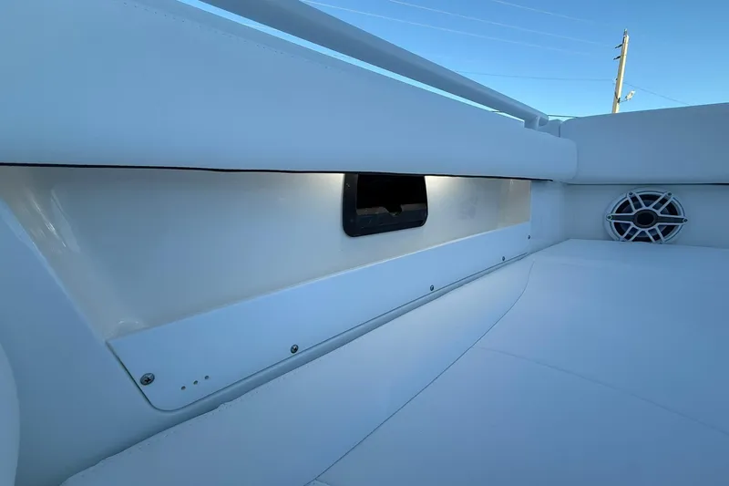Slide: The Image of 2026 Crevalle 33 CSF boat interior with speaker and storage compartment. - 55