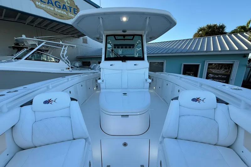 Slide: The Image of 2026 Crevalle 33 CSF boat interior with white seating and fishing rod holders. - 61
