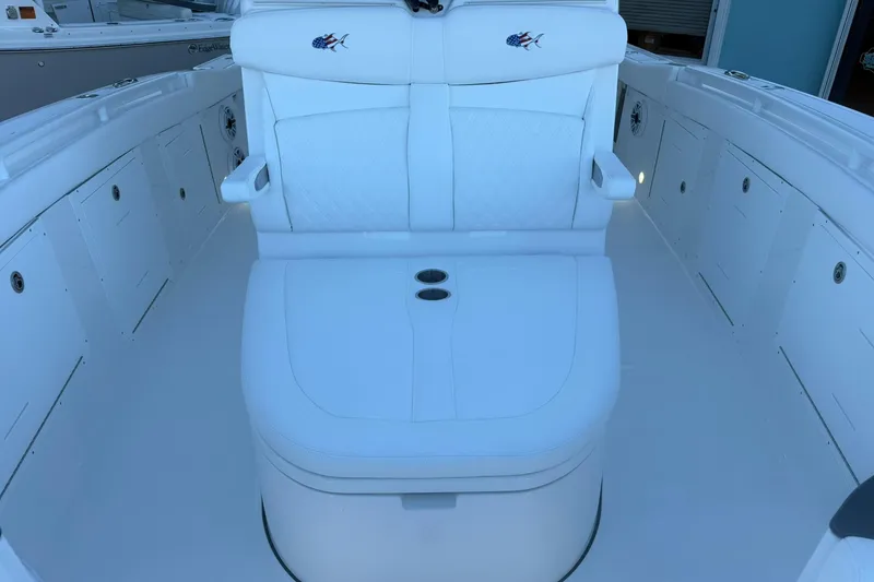Slide: The Image of 2026 Crevalle 33 CSF boat interior with white seating and storage compartments. - 65
