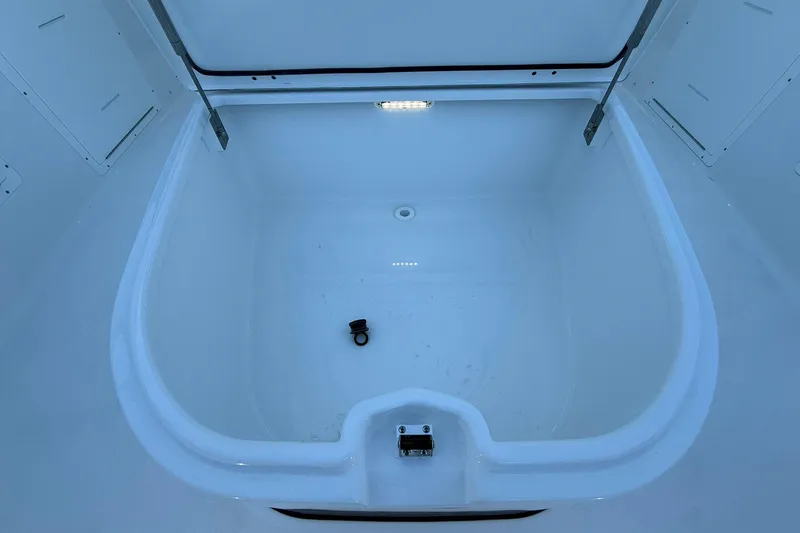 Slide: The Image of 2026 Crevalle 33 CSF boat storage compartment with open lid and interior light. - 66
