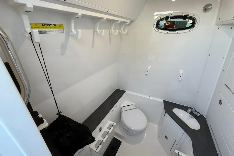 Slide: The Image of 2026 Crevalle 33 CSF boat interior with toilet and sink, featuring modern design. - 68