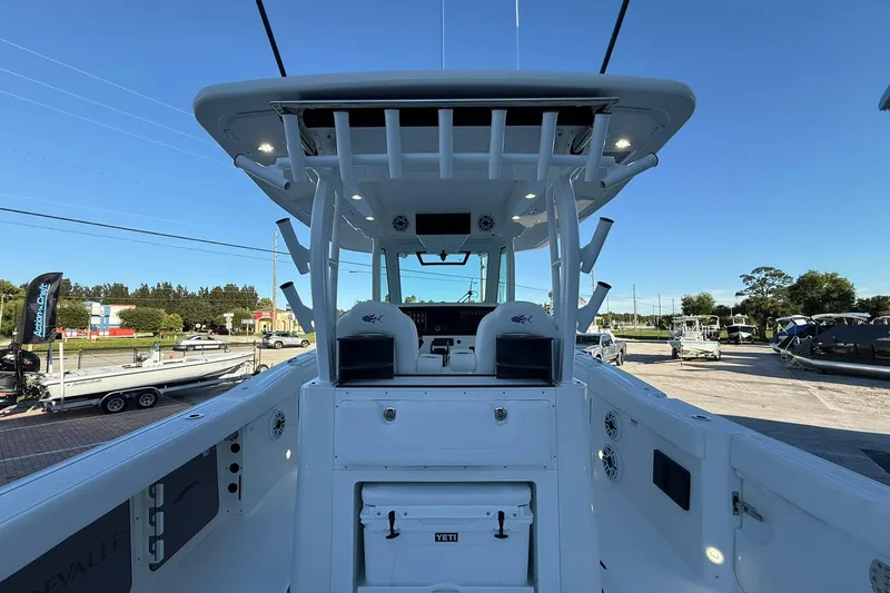 Slide: The Image of 2026 Crevalle 33 CSF boat interior with helm station and seating, under clear blue sky. - 7