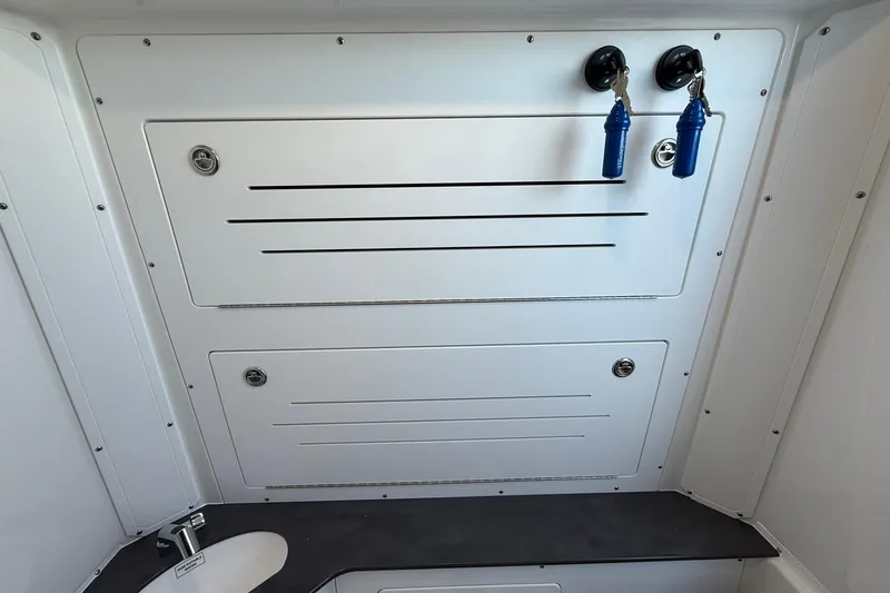 Slide: The Image of Interior of 2026 Crevalle 33 CSF boat with storage compartments and keys. - 70