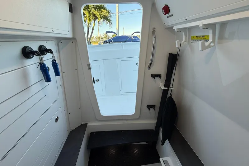 Slide: The Image of Interior view of 2026 Crevalle 33 CSF boat cabin with seating and storage hooks. - 73