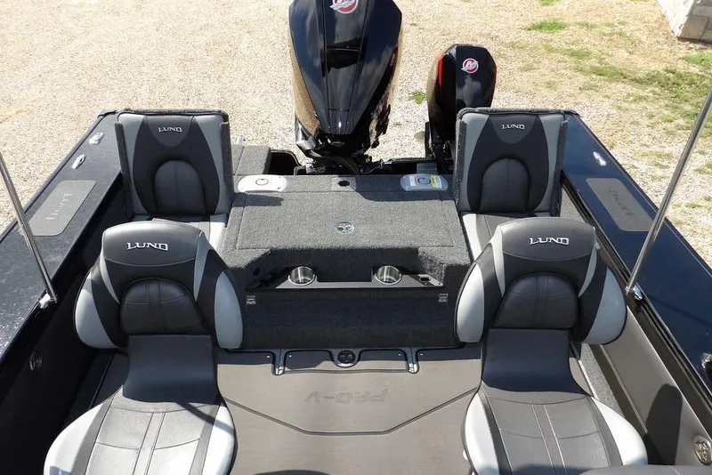 Slide: The Image of 2026 Lund 2075 Pro-V Sport boat interior with four seats and motor. - 14