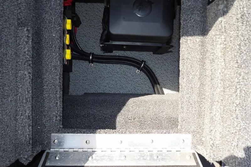 Slide: The Image of Interior view of 2026 Lund 2075 Pro-V Sport boat compartment with wiring and battery. - 16