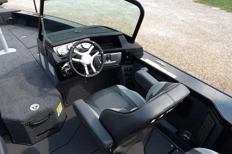 Slide: The Image of 2026 Lund 2075 Pro-V Sport boat interior with steering wheel and seating. - 19