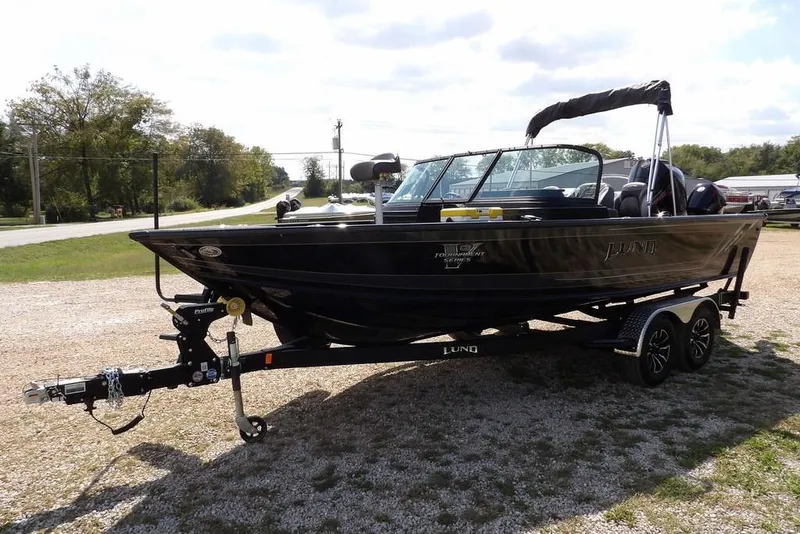 Slide: The Image of 2026 Lund 2075 Pro-V Sport boat on trailer, parked outdoors. - 2